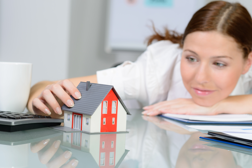 Woman holding model house